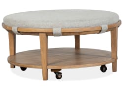 Lindon - Round Cocktail Table With Gray Upholstered Top & Casters - Belgian Wheat