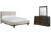 Tauren - California King Upholstered Panel Bed And Double Drawer Dresser With Shaped Mirror - Coffee Bean / Beige