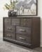 Brueban - Rich Brown - 7 Pc. - Dresser, Mirror, California King Panel Bed with 2 Storage Drawers, 2 Nightstands