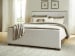 Radkin - California King Upholstered Panel Bed - Burnished Brown